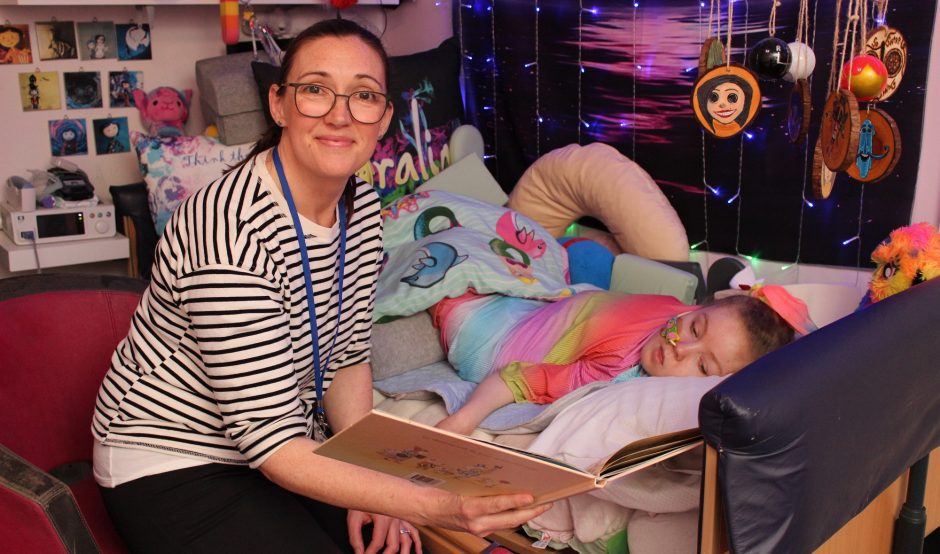 Homecare team nurse Alison reading a story to a child