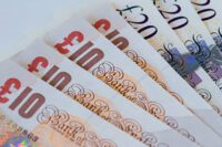 Ten and twenty pound notes spread out in a fan shape