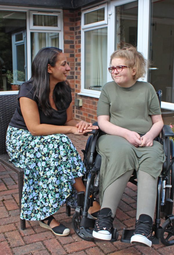 Woman seated with a young person in a wheelchair