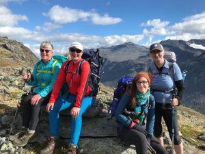 Trekkers sat on a mountain in Norway