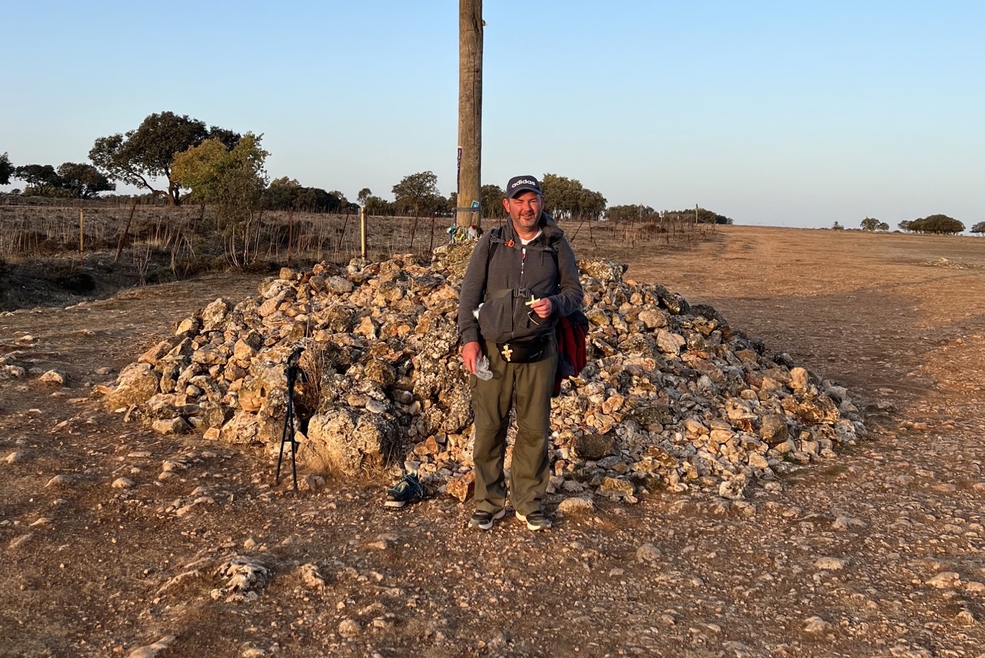 Peter Scanlon stood by a crucifix and mount of stones