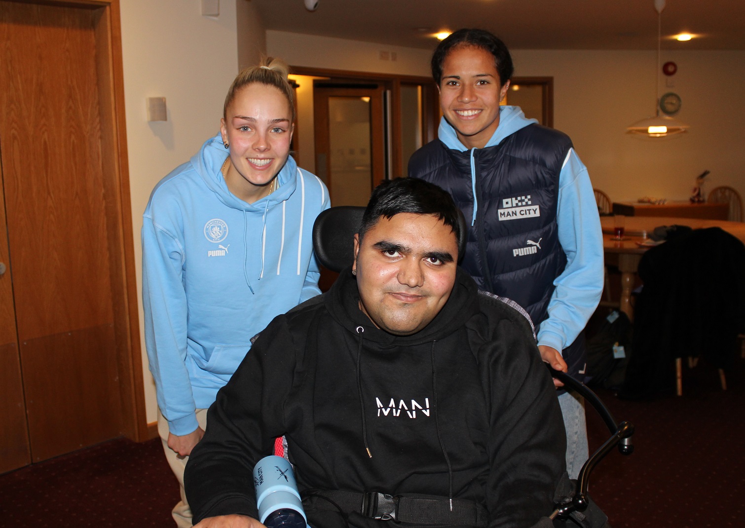 Manchester City players with young person at Francis House