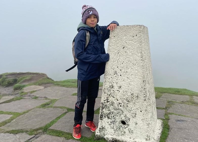 Boy stood at the top of a misty hill