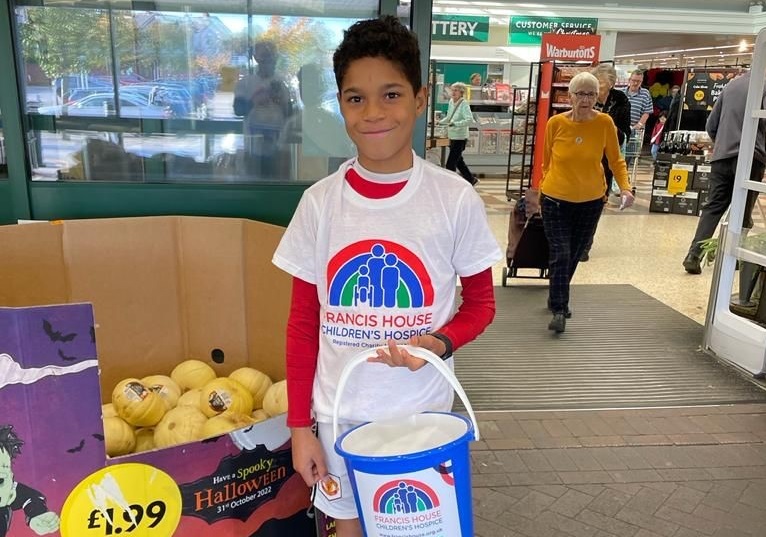 Boy holding a charity collection bucket