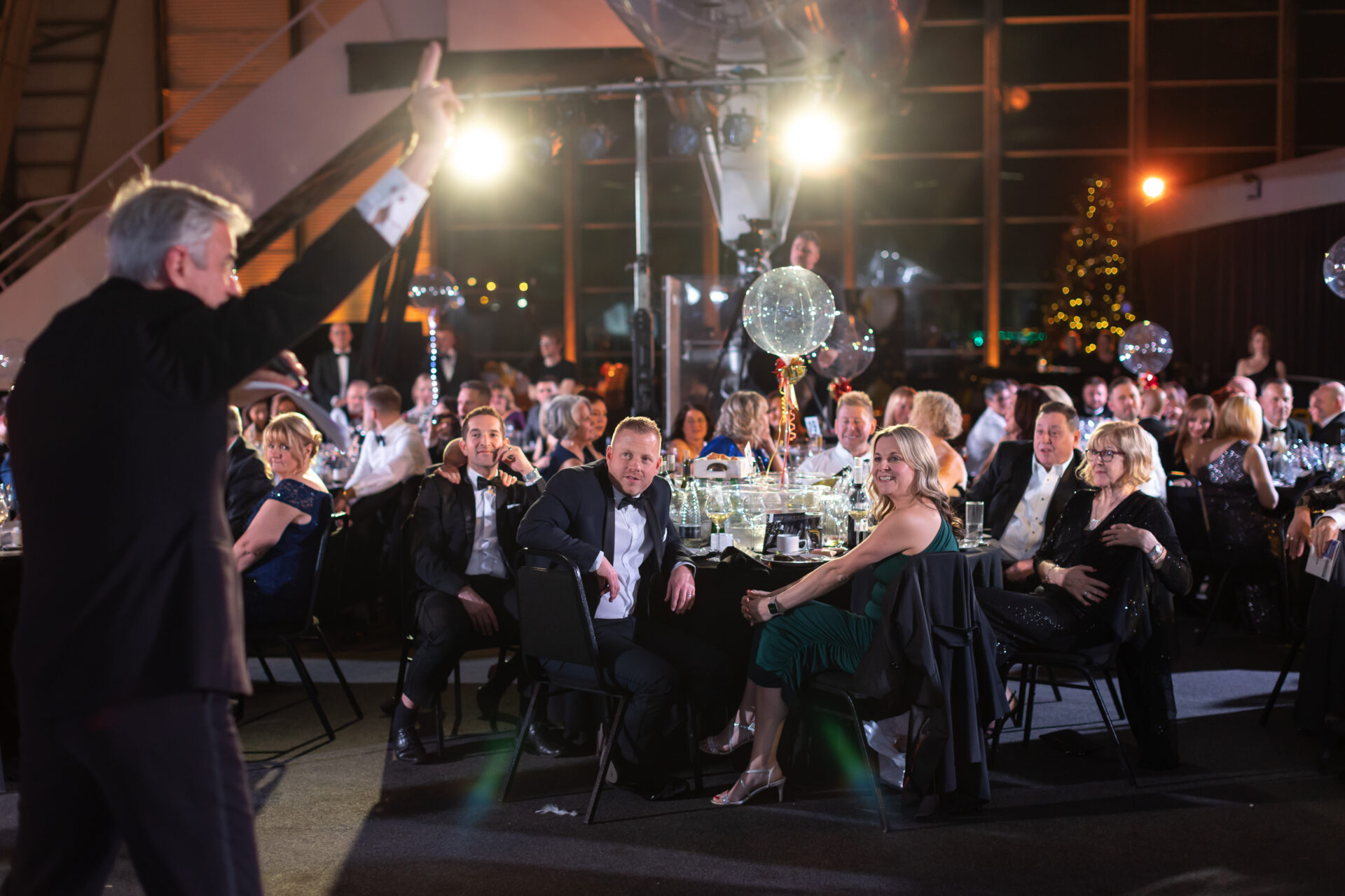 Auctioneer stood in front of audience at charity ball