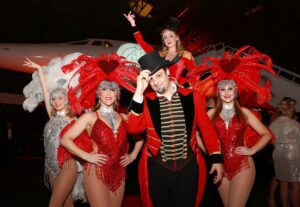 Dancers and showman in circus costume