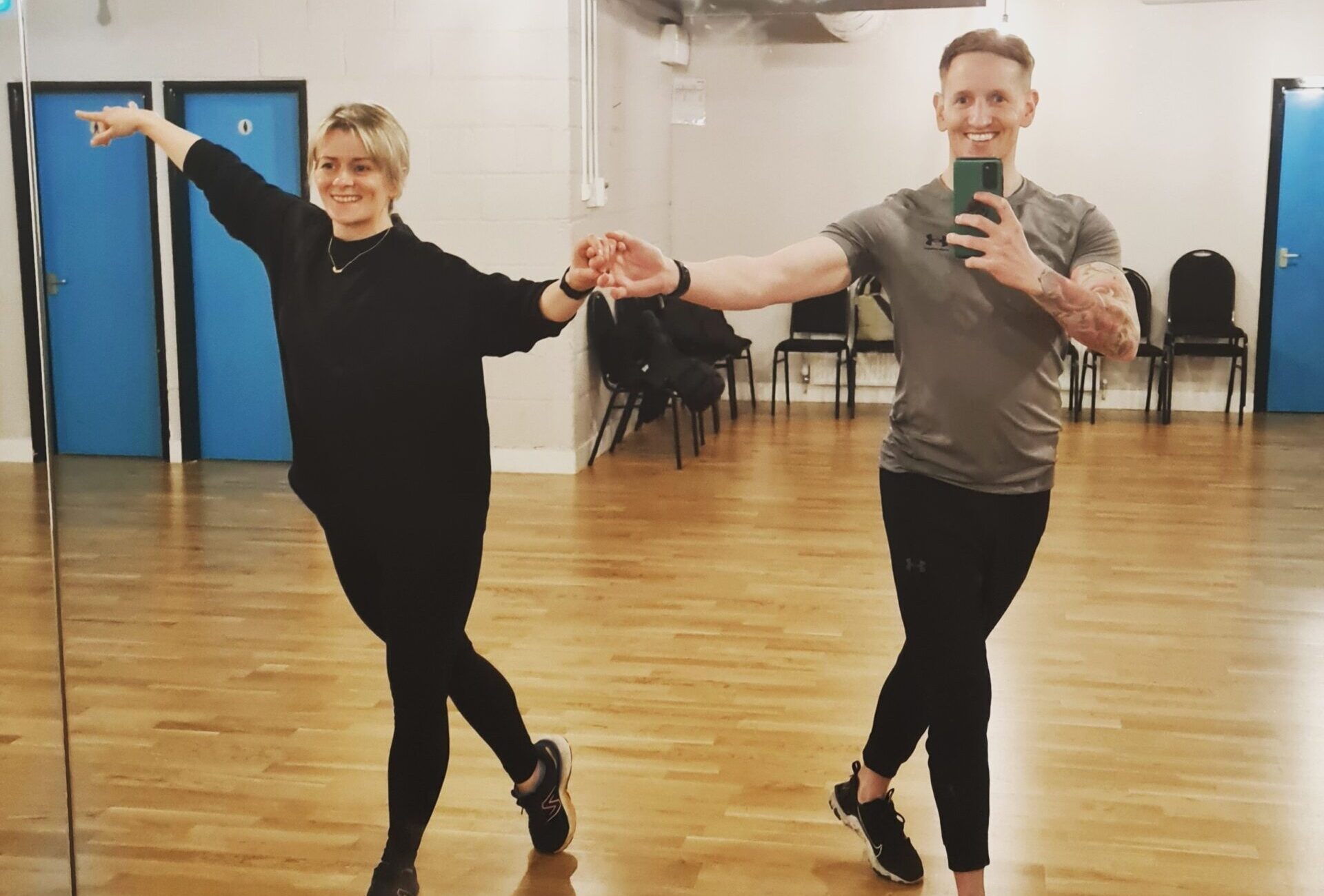 Two people dancing in a dance studio