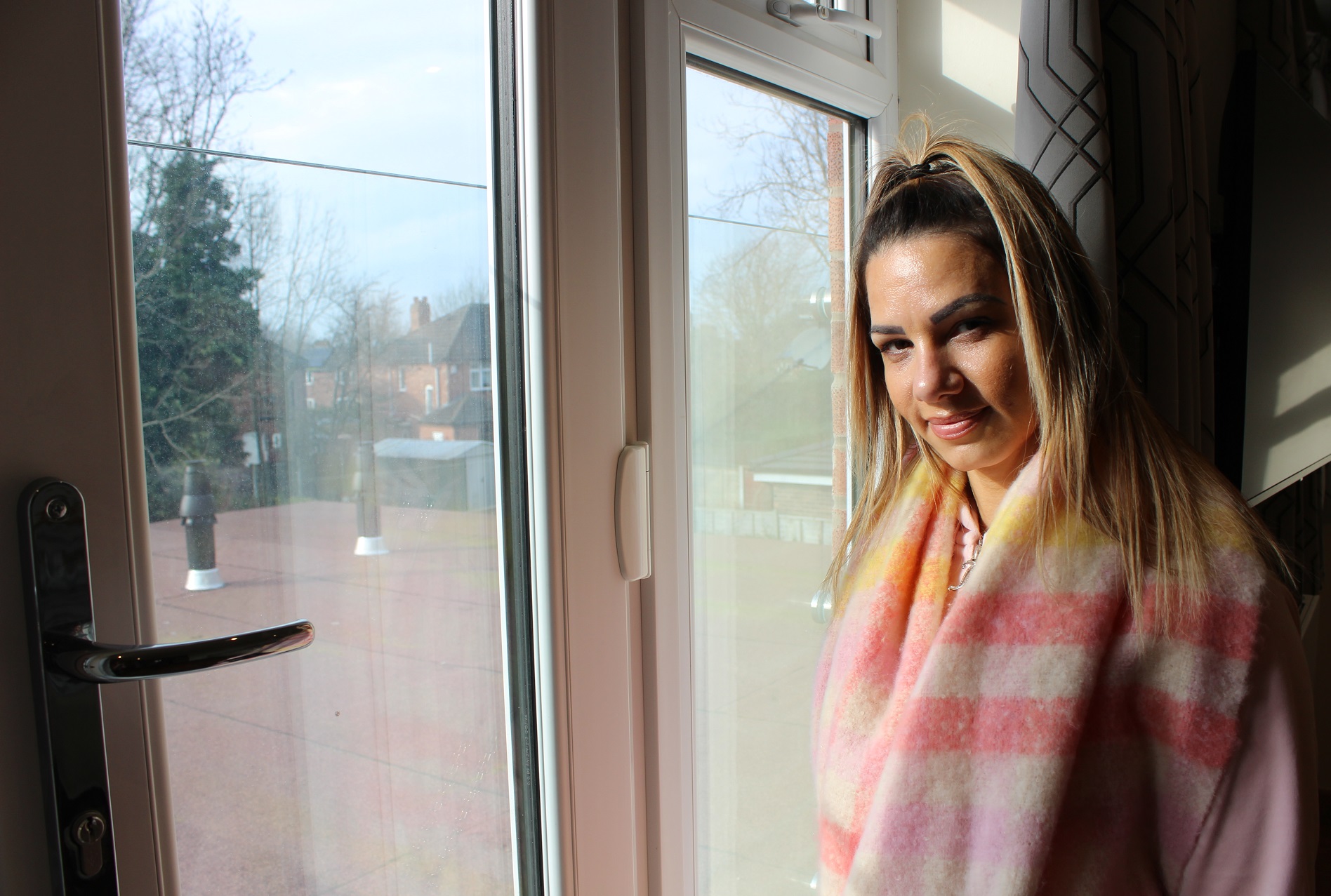 Woman looking out of window smiling