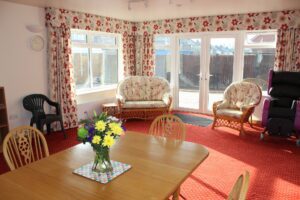 Lounge with chairs and table overlooking garden