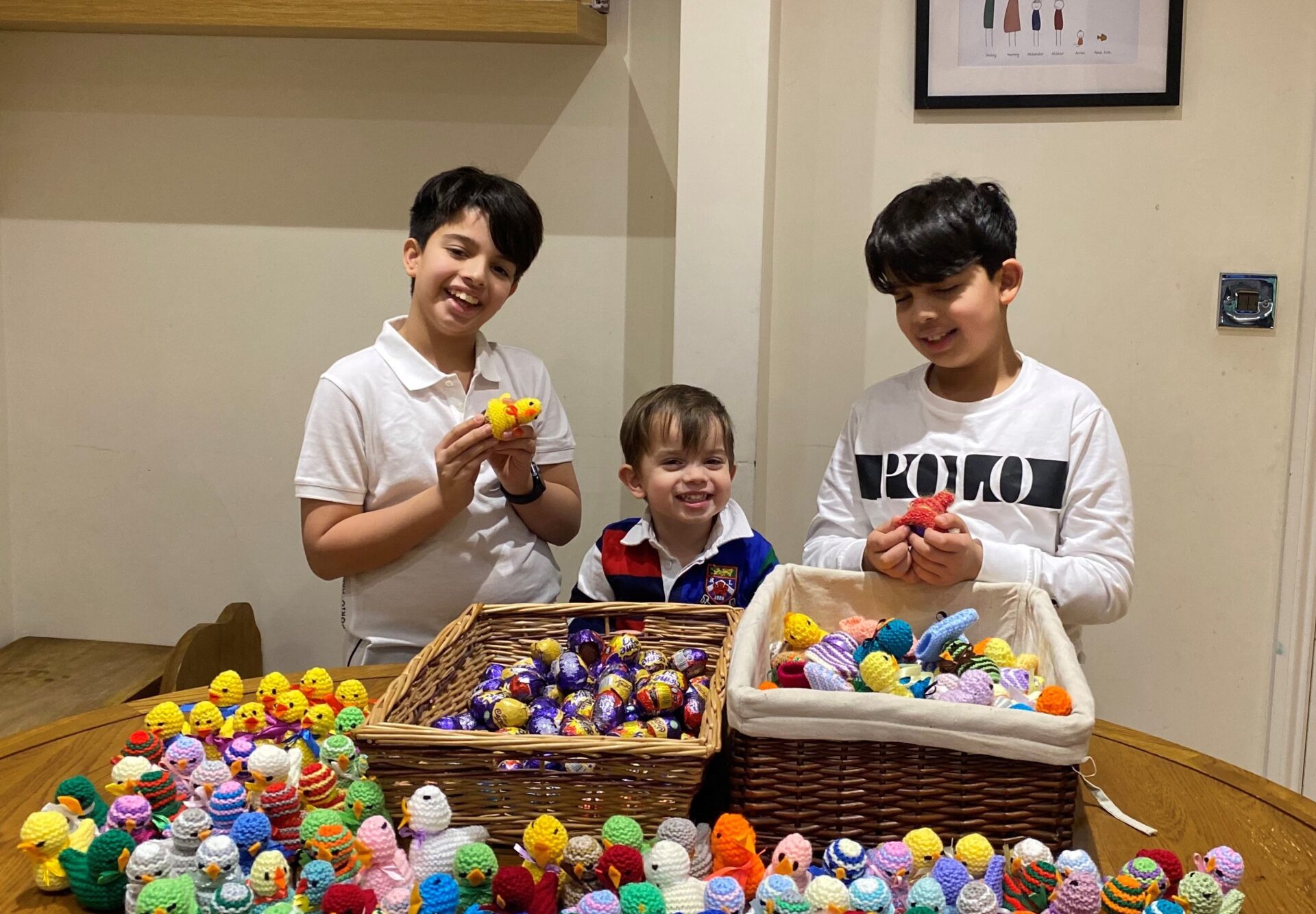 Three boys with hampers of knitted chicks and chocolate eggs