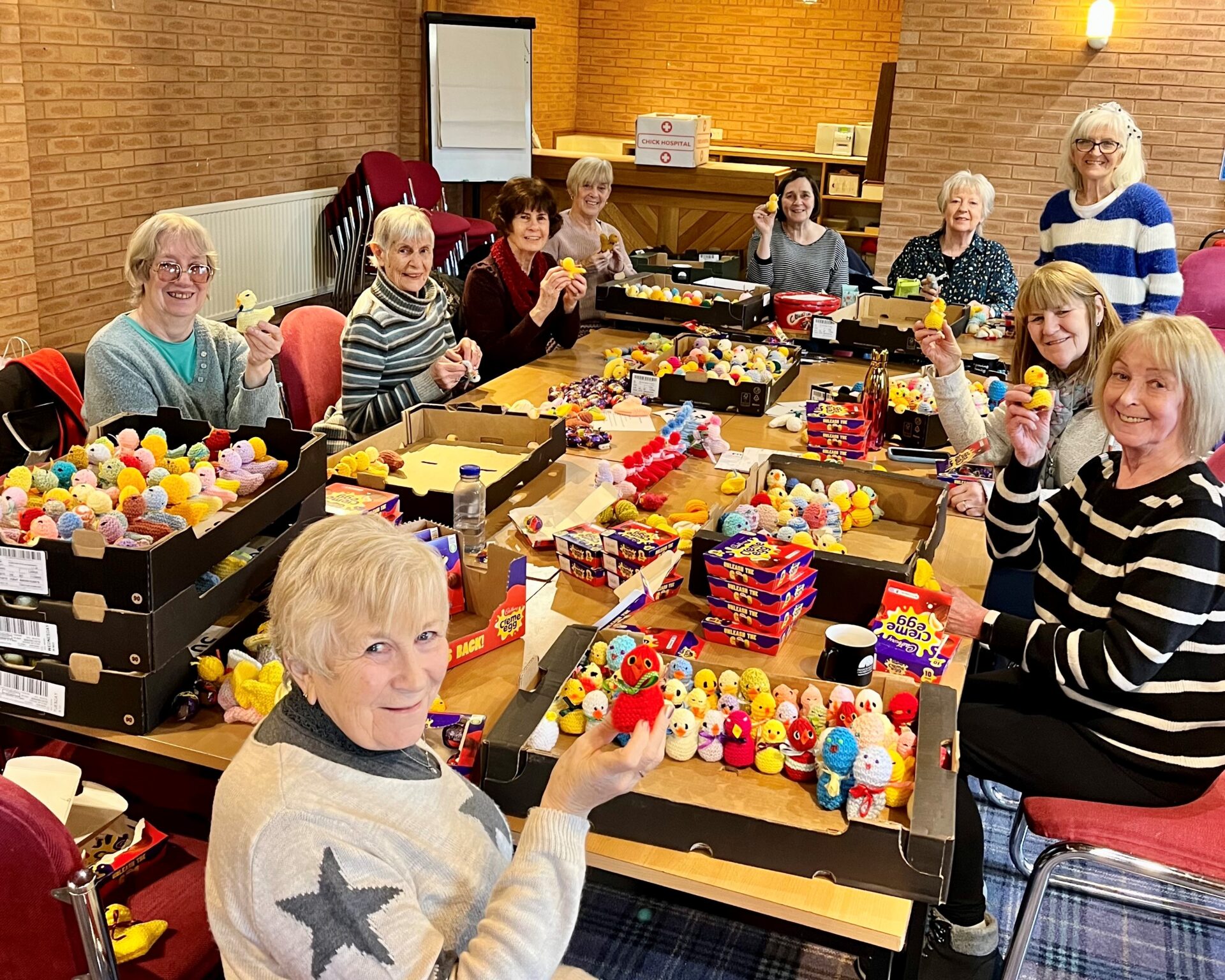 Group of women with boxes of knitted chicks