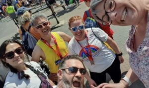 Group of people wearing tshirts and medals stood on a street