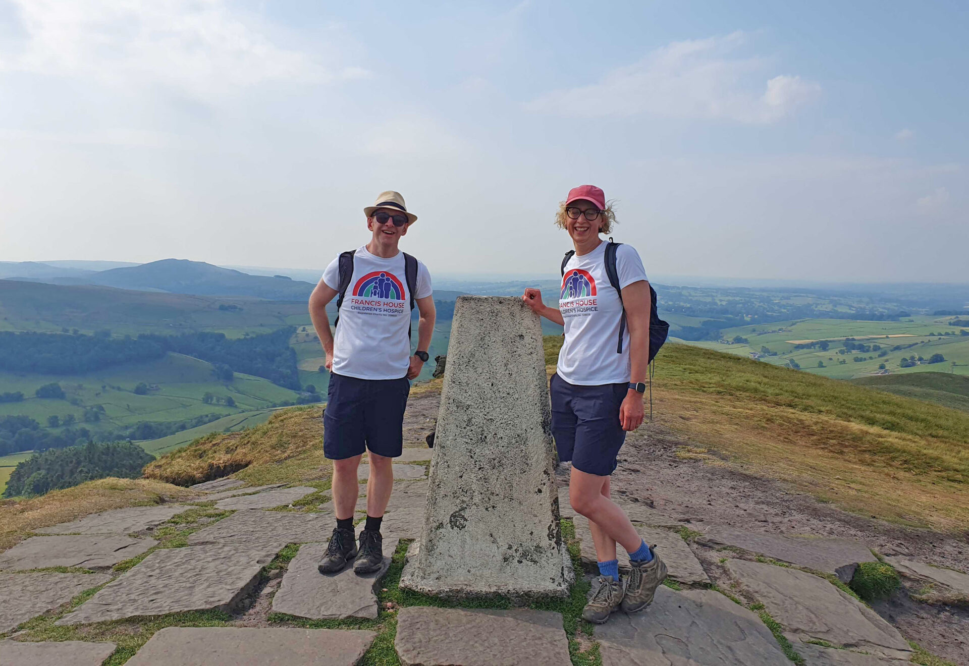 Two hikers stood at the top of a hill