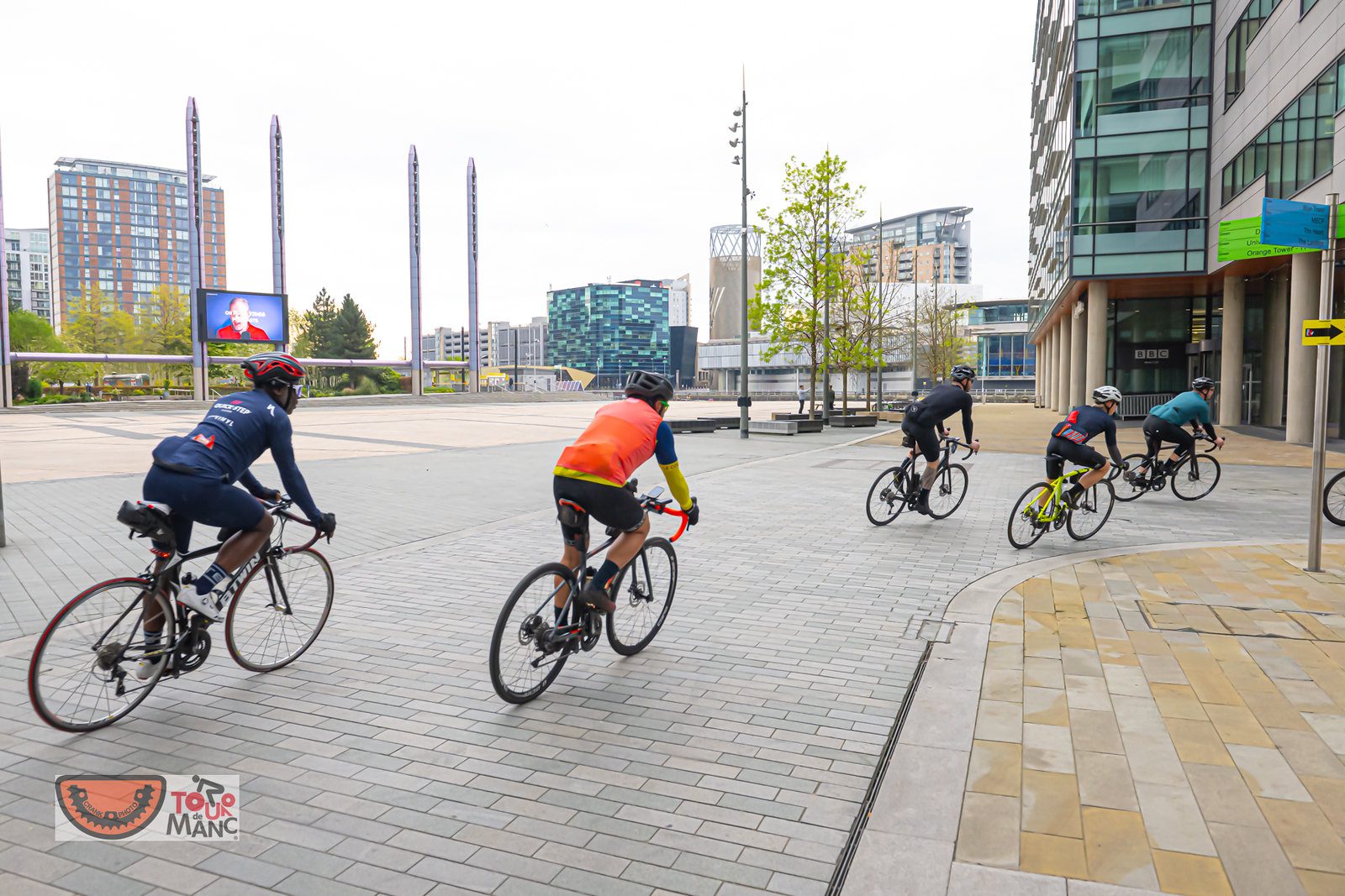 A group of cyclists passing through Media City