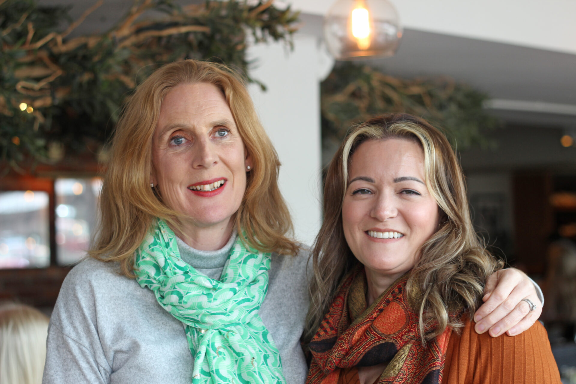 Two women stood in a restaurant