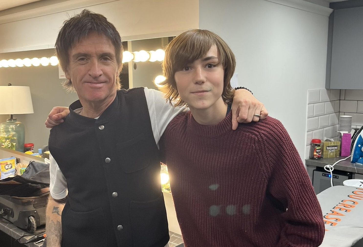Johnny Marr stood with John Denton in a back stage room