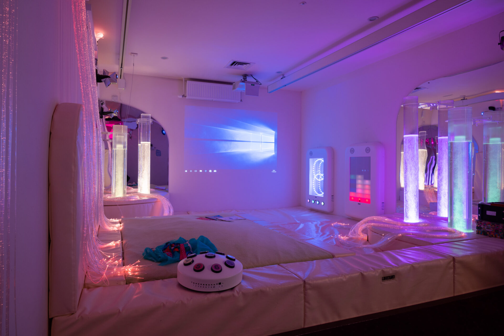 Multi-sensory room with blue lighting and bubble tube lights