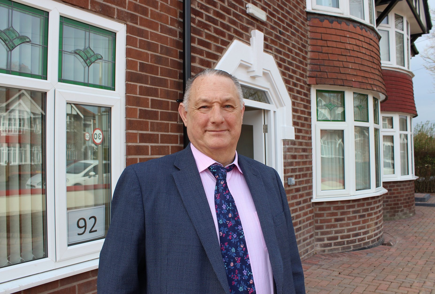 Man stood outside a brick building