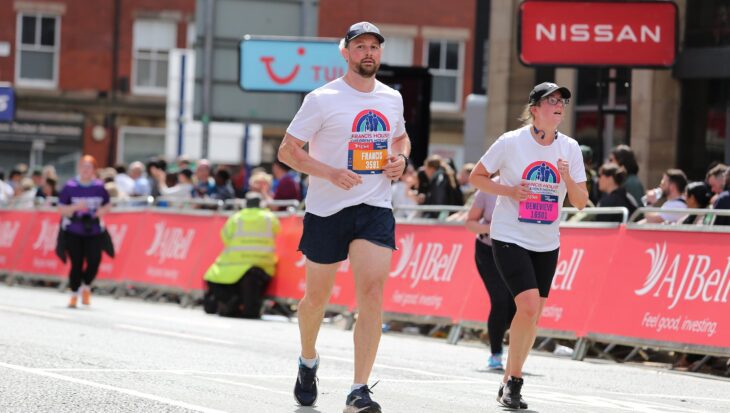 Two people running down a street at the Great Manchester Run