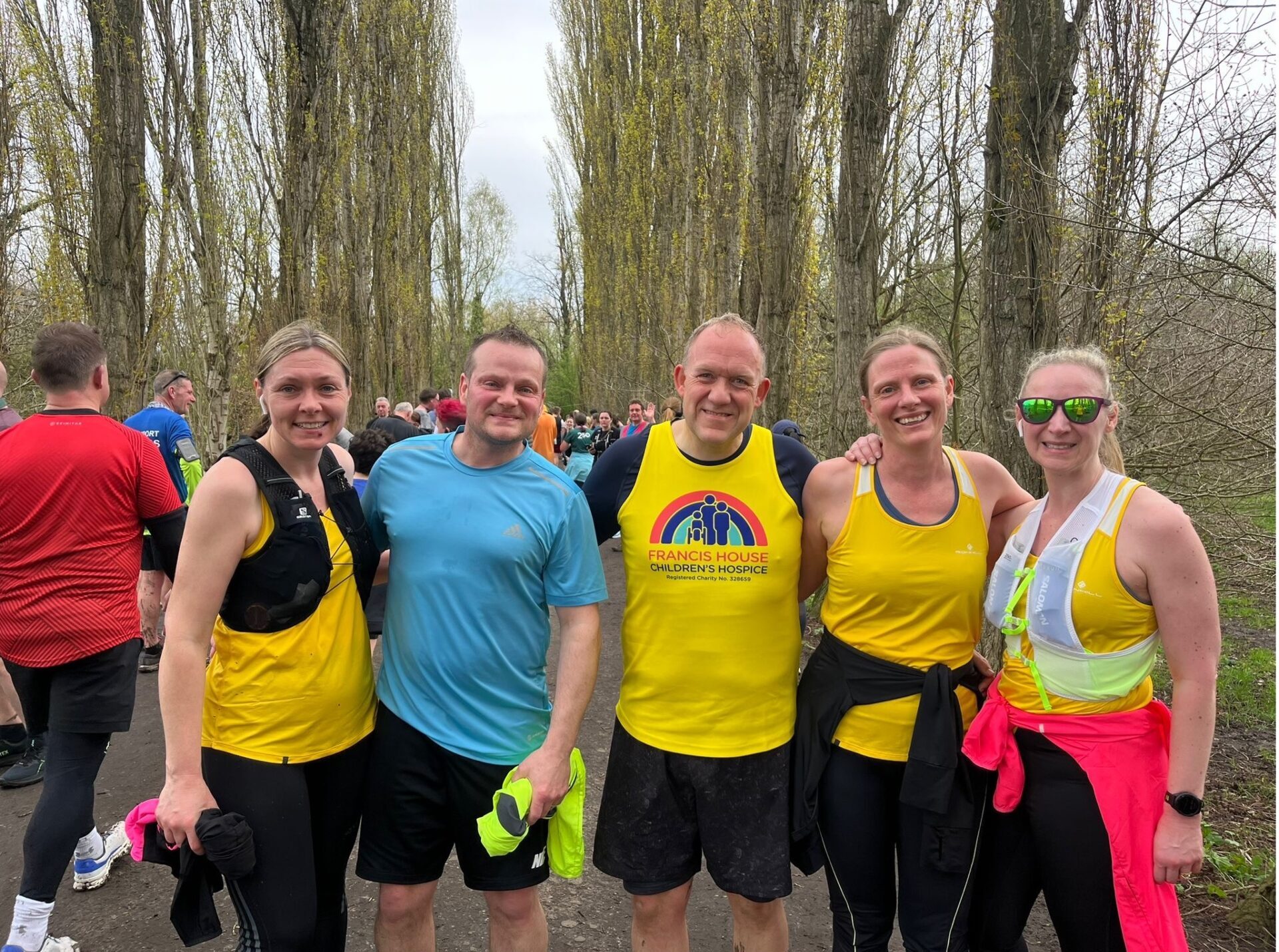 Four people running in a park