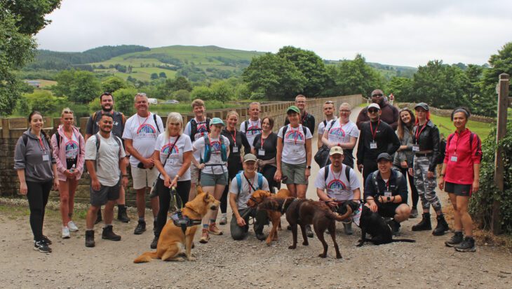 Large group of walkers and pet dogs stood at Tegg's Nose reservoir