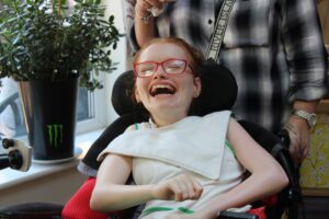 Young woman in a wheelchair laughing