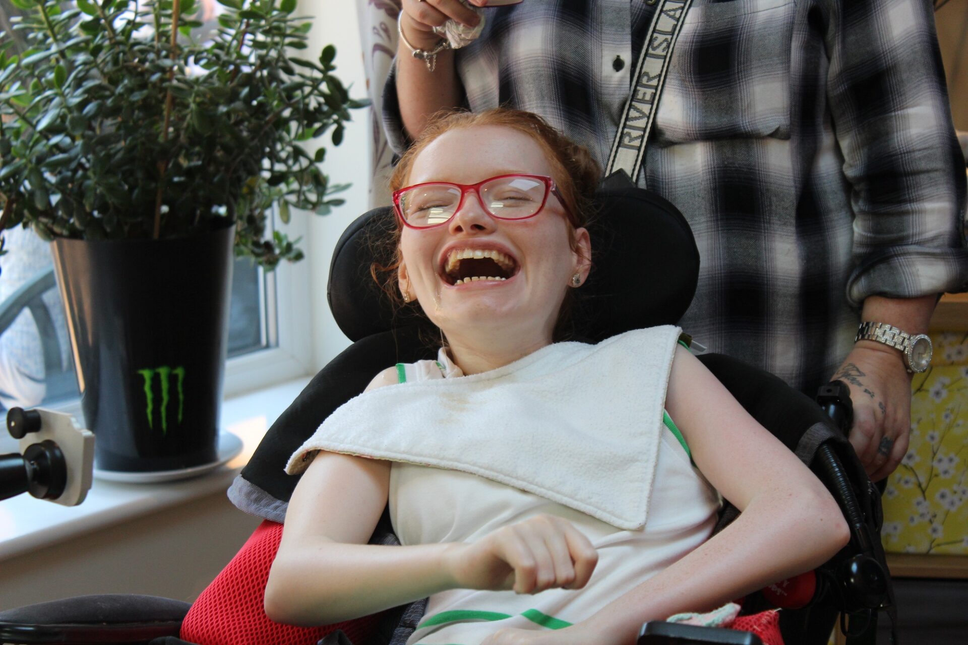 Young woman in a wheelchair laughing