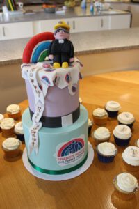 Cake decorated with a man character and rainbow