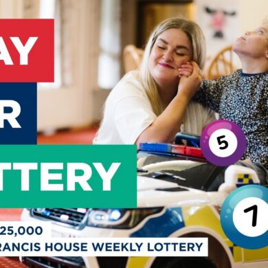 Poster advertising a lottery featuring a picture of a woman and child smiling with colourful lottery balls