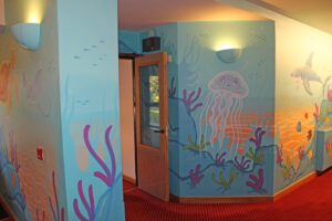 Painted undersea mural of cartoon creatures on a wall