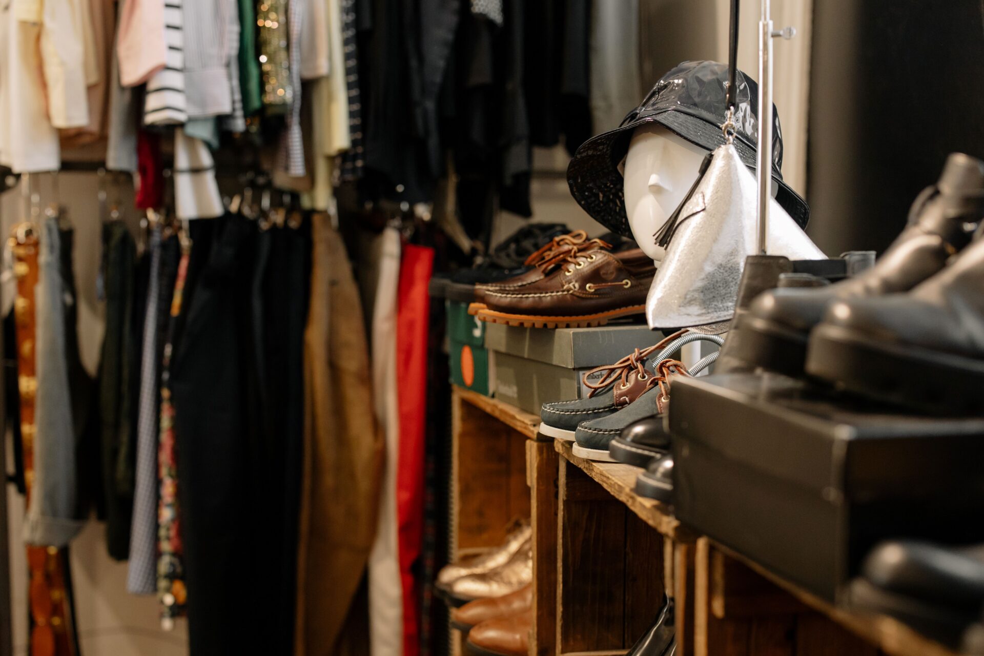 charity shop clothing and shoe items on shelves